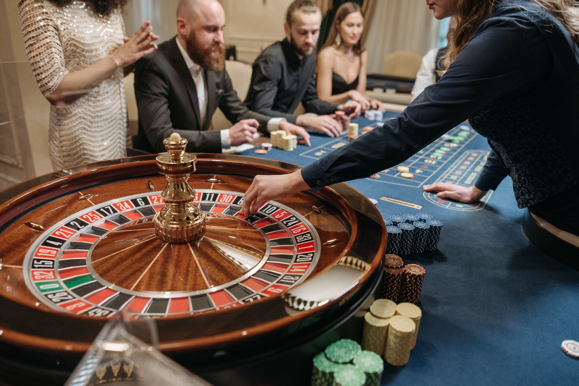 A vibrant casino scene shows players and a dealer engaging in a game of roulette. — The Evolution of Casino Gaming: From Trad