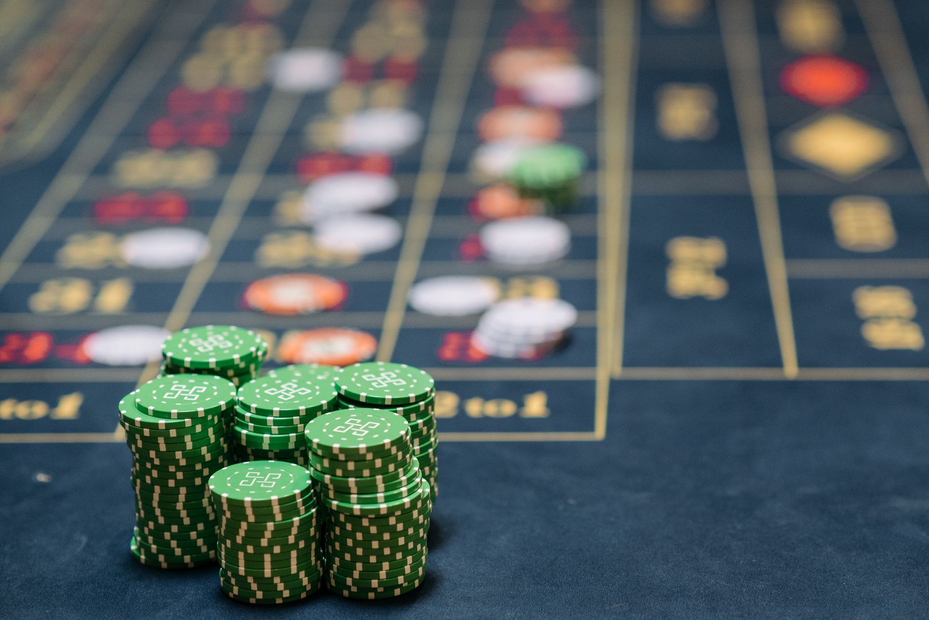 Stack of green poker chips on a casino table, highlighting the gambling theme. — The Evolution of Casino Loyalty Programs