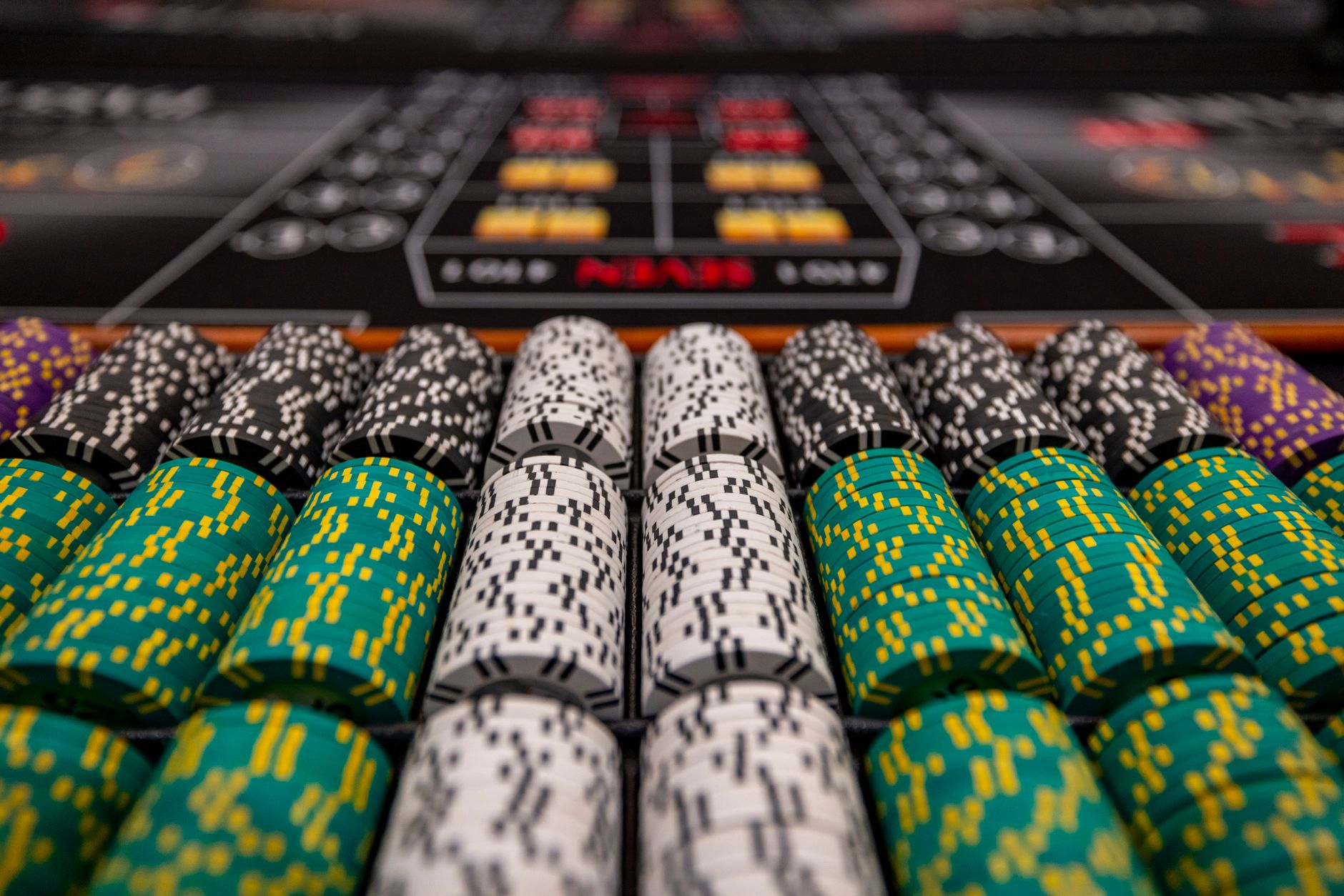 Close-up of colorful casino chips arranged on a gaming table, ready for play. — The Future of Live Dealer Games in Online Cas