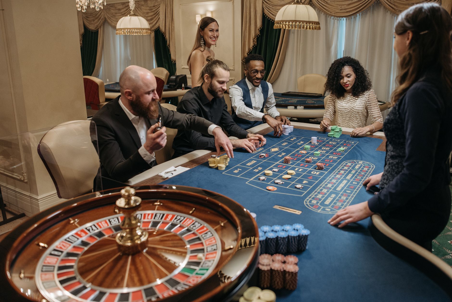 A lively casino scene with diverse people playing roulette at a gaming table. — The Impact of Artificial Intelligence on Casi