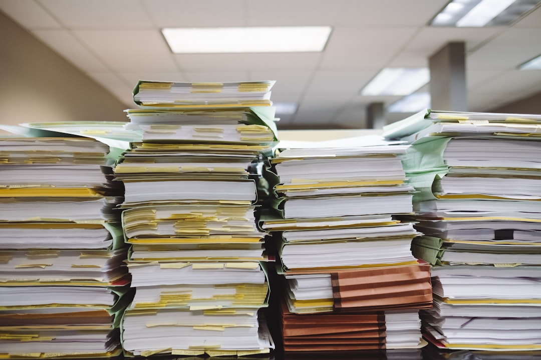 A stack of organized file folders indicating a paperwork process.