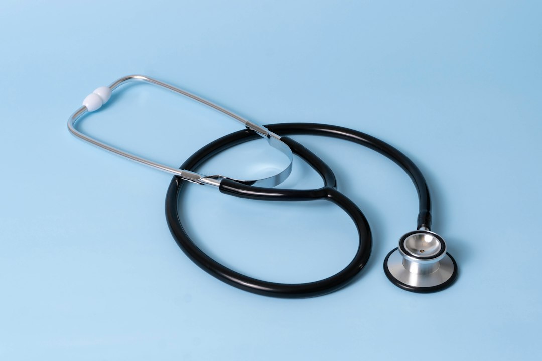 A stethoscope laid on a light blue background